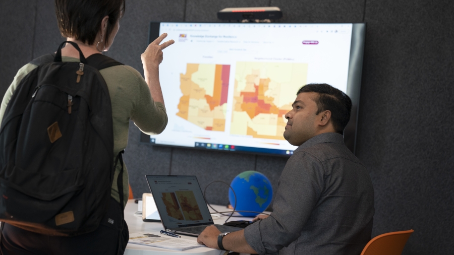 Sarbeswar Praharaj, KER's Associate Director for Data and Visualization, demonstrates his poverty dashboard with an Open House guest.