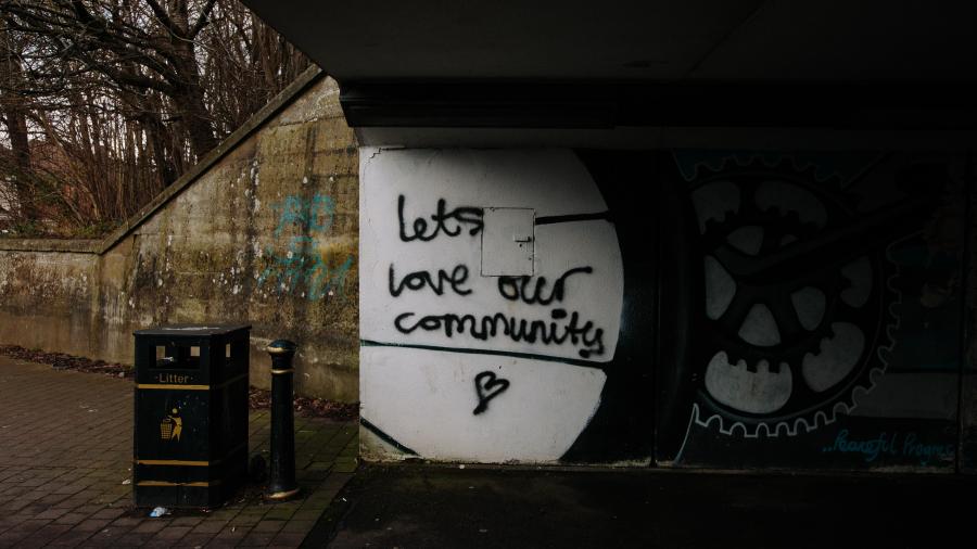 Graffiti that reads "Let's love our community"
