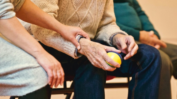 Family caregiver holding an elder's arm