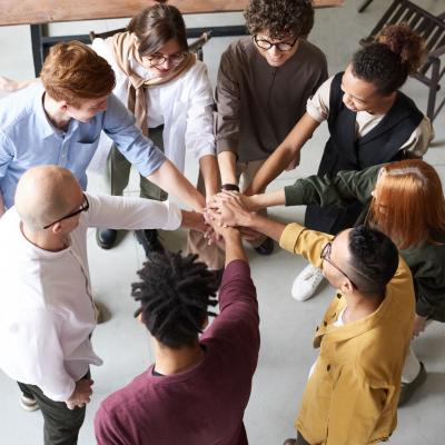 Hands in; a work team doing a motivation circle