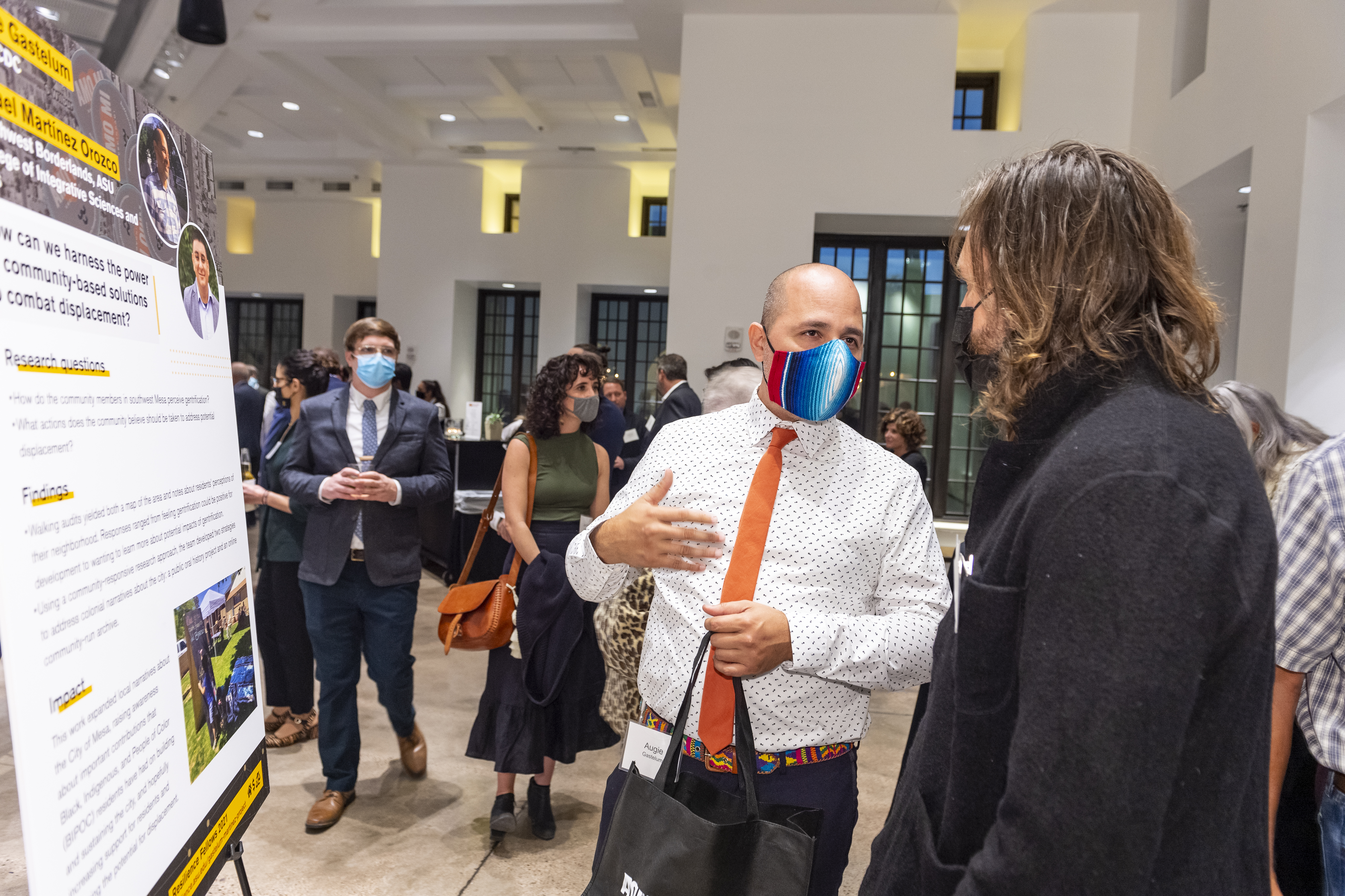 2021 Resilience Fellow discussing his project with a Celebration attendee