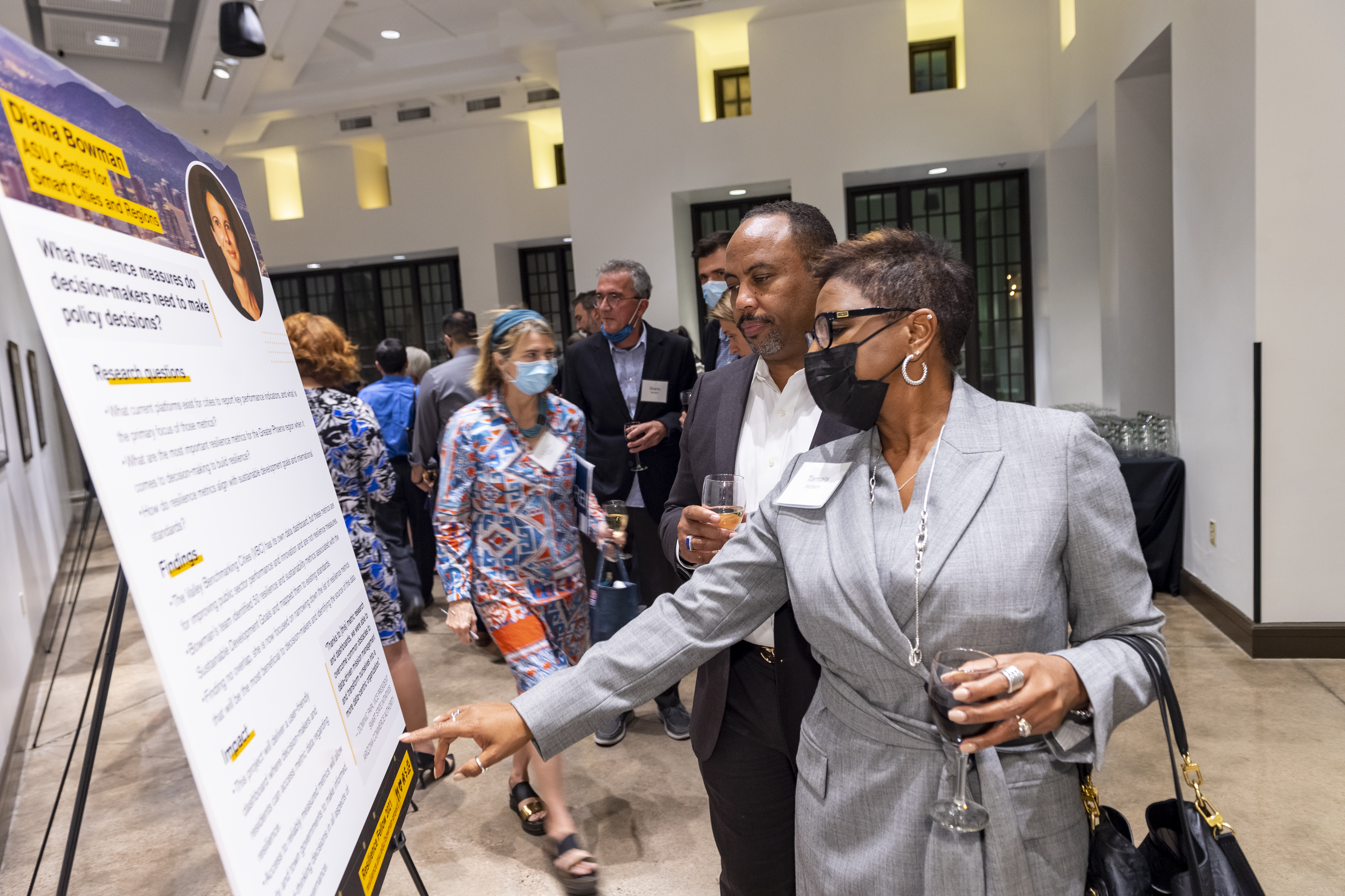 2021 Celebration for Resilience attendees read Diana Bowman's poster to learn about her fellowship project