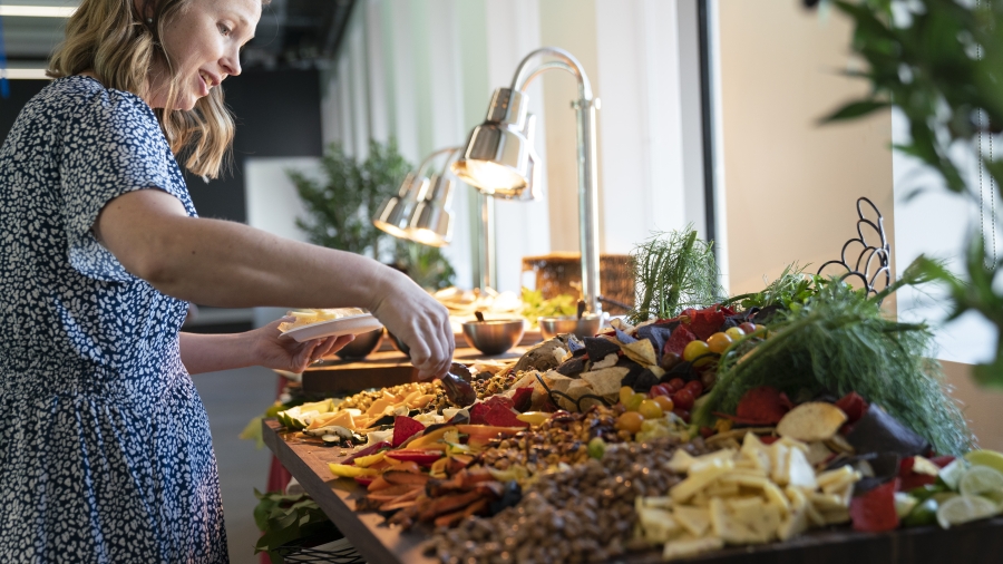 An Open House guest grabs appetizers at the buffet.