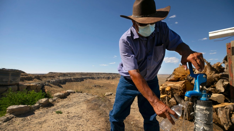 Man on reservation pumping water during a drought