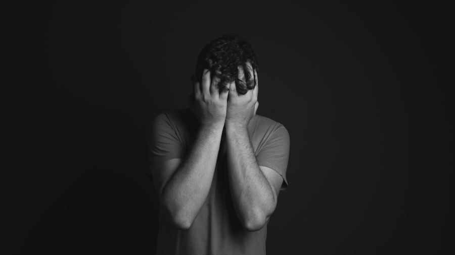 A person covering their face with their hands