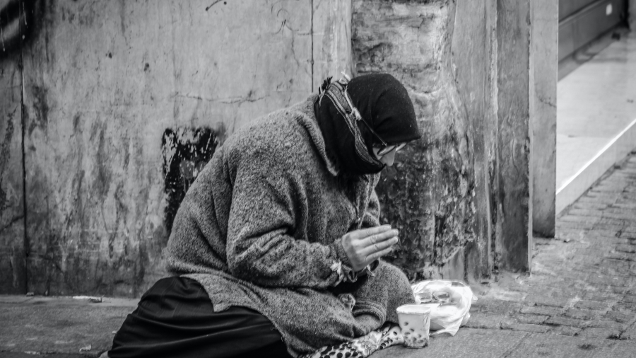 Unhoused person on a sidewalk