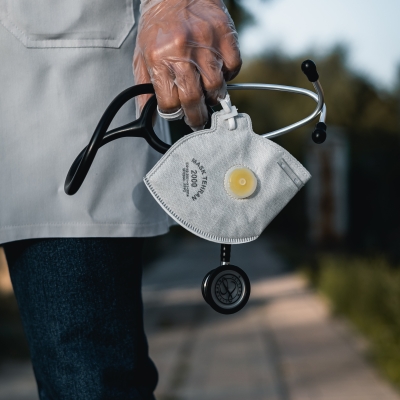 Doctor holding a mask and stethoscope