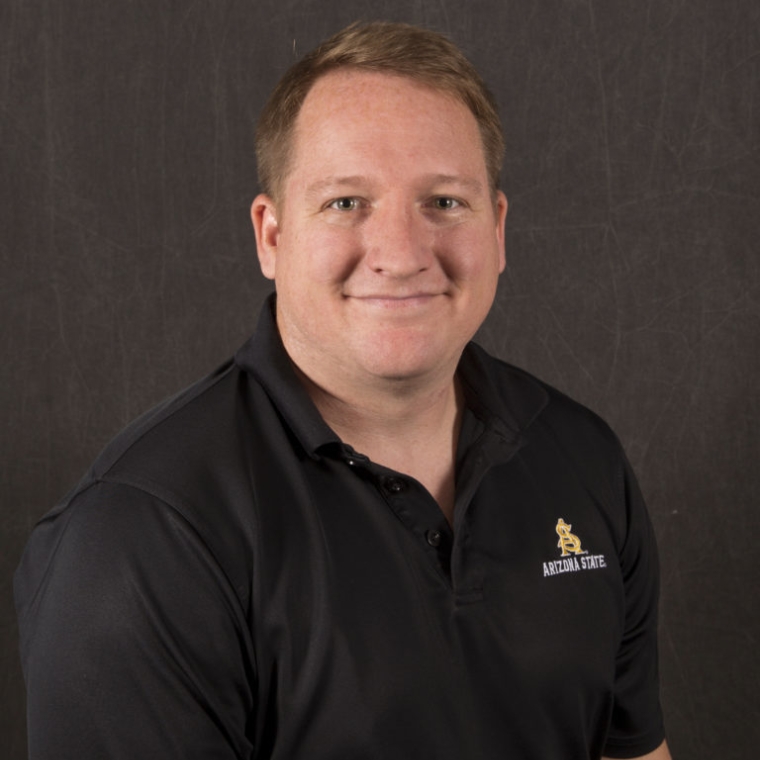 Joshua Loughman smiling in a black polo
